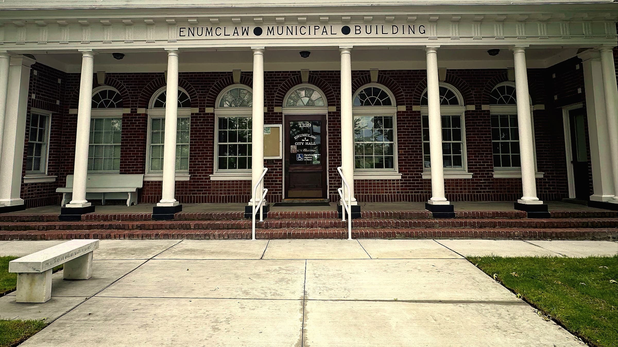 The white pillars and red brick of Enumclaw's 1922 Municipal Building on Griffin Avenue