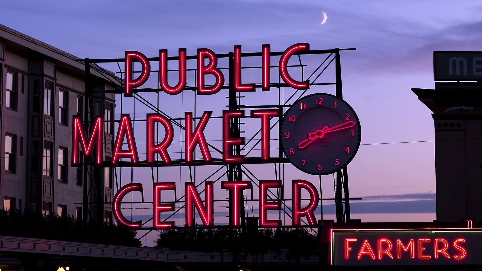 A red neon sign reading PUBLIC MARKET CENTER with a round clock of glowing red numerals and hands at its right, against a purple dusk sky with a thin crescent moon, a building at left and a red FARMERS sign at lower right.